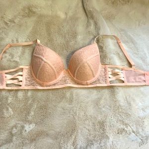 Lacy pink bra with side straps and triple hooks